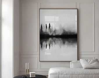 May include: A black and white abstract painting of a foggy forest reflected in a still lake. The painting is framed and hanging on a white wall above a white sofa.