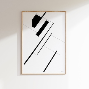 Puede incluir: Impresión de arte geométrico abstracto en blanco y negro con un diseño simple de líneas y formas. La impresión está enmarcada en un marco de madera claro.