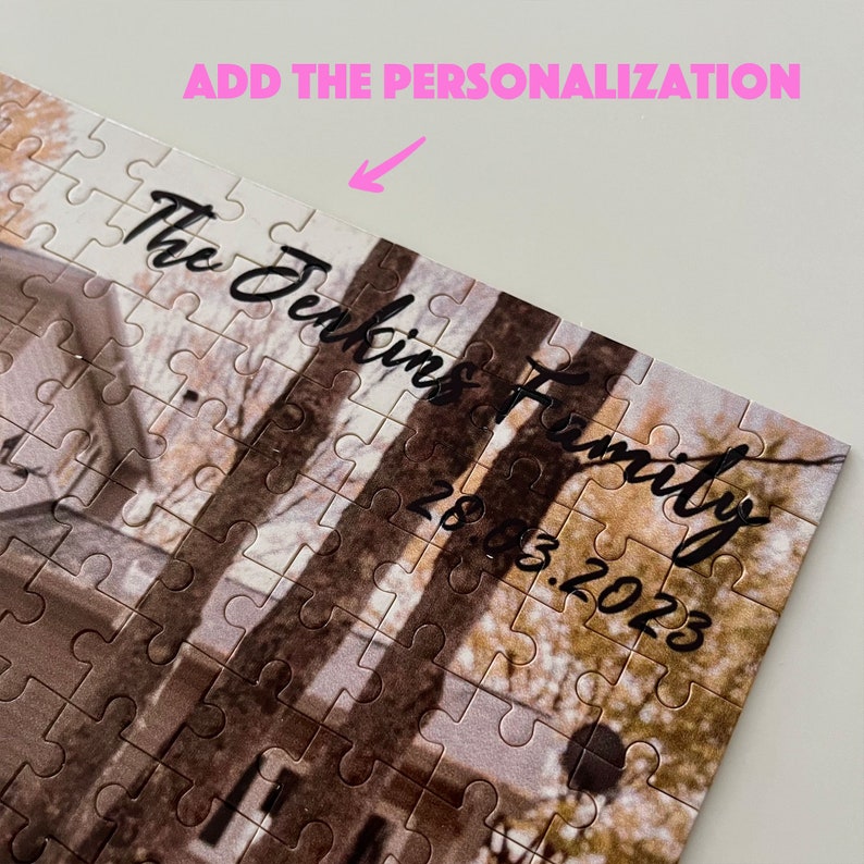 May include: A personalized jigsaw puzzle with a wintery scene of a house and trees. The text "The Jenkins Family 20.03.2023" is written in black cursive on the puzzle.