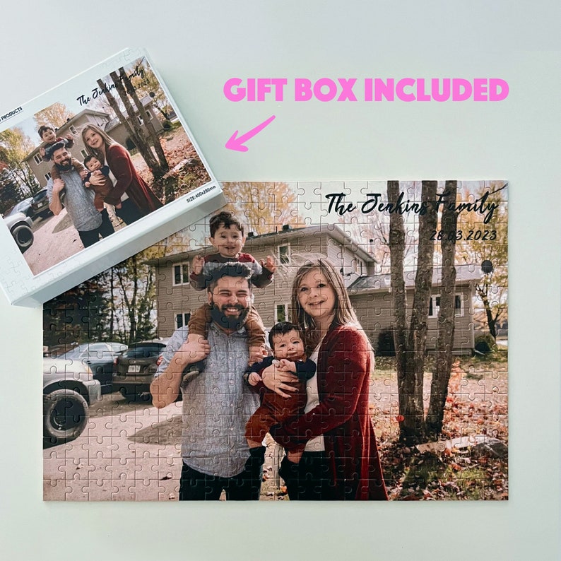 May include: A personalized jigsaw puzzle featuring a family of five standing in front of a house. The puzzle is white with a colorful image of the family. The text "The Jenkins Family 26.12.2023" is printed on the puzzle.