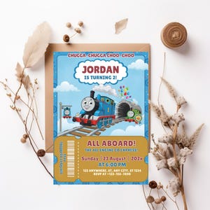 May include: A rectangular birthday invitation card featuring a blue train character with the number 1, a green train, and the text CHUGGA-CHUGGA CHOO-CHOO, JORDAN IS TURNING 2, ALL ABOARD, THE ALL ENGINE GO EXPRESS, Sunday 23 August 202x at 6:00 PM.