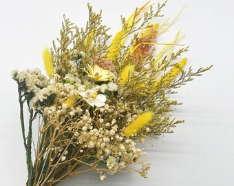 May include: A bouquet of dried flowers in shades of yellow and white. The bouquet includes baby's breath, dried grasses, and small yellow flowers.