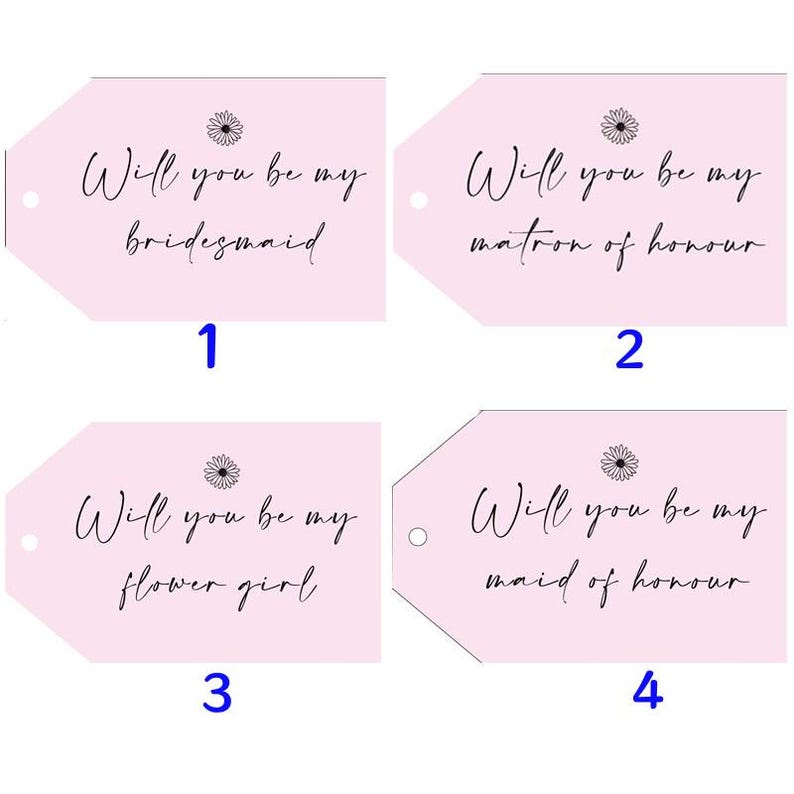 May include: Four pink gift tags with the text "Will you be my bridesmaid", "Will you be my matron of honor", "Will you be my flower girl", and "Will you be my maid of honor". Each tag has a small daisy graphic.