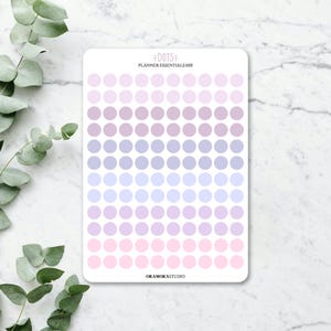 May include: A sticker sheet featuring a gradient of pastel dots in shades of pink, lilac, and blue. The text "DOTS PLANNER ESSENTIALS 005" is at the top, and "ORAMORASTUDIO" is at the bottom. The sticker sheet is on a white background.