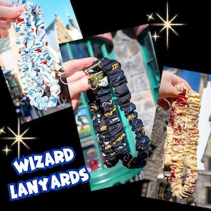 May include: Wizard lanyards in various patterns. One is white with red and blue graphics, another is black with white and yellow graphics, and the third is cream with red graphics. The lanyards have gold-colored metal clasps.