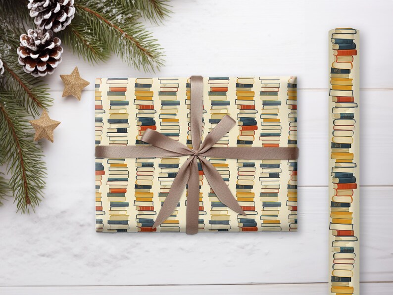 May include: A gift wrapped in brown paper with a book stack pattern. The paper is cream colored with stacks of colorful books printed on it. The gift is tied with a brown ribbon.