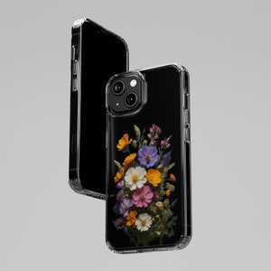 May include: A clear phone case with a pressed flower design. The case features a bouquet of yellow, orange, pink, purple, and white flowers on a black background.
