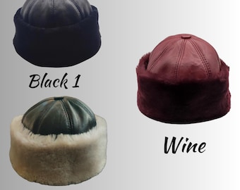 May include: Three dome-shaped hats featuring a smooth leather crown and a thick, plush faux fur brim. The hats are labeled Black 1, Black 2, and Wine, showcasing a black leather with black fur, dark green leather with white fur, and wine leather with wine fur.