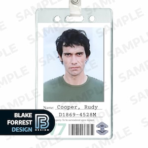 May include: Clear plastic ID badge with a photo of a person wearing a green shirt. The badge includes the name "Cooper, Rudy" and the ID number "D1869-4528M". The badge also features a barcode and the "Blake Forrest Design" logo.