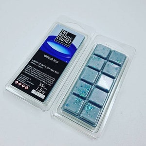 May include: A clear plastic container with a blue and white soy wax melt inside. The wax melt is labelled "Vapour Rub" and "Highly Scented Soy Wax Melt". The container is 55g or 1.9 oz.