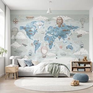 May include: A wall mural featuring a vintage-style world map in shades of blue and grey. The map includes illustrations of hot air balloons, sailing ships, aeroplanes, clouds, and various animals across the continents, with text labels for oceans.