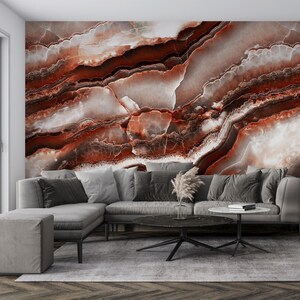 May include: A large wall mural featuring a high-resolution print of polished agate stone with deep red, burnt orange, and creamy white swirling bands. The pattern displays organic, layered mineral textures that span the entire wall surface.