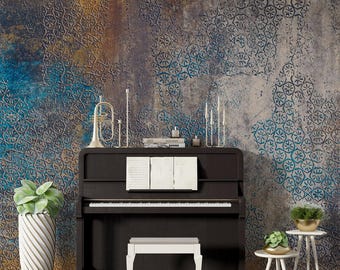 May include: A black upright piano with a white bench in front of it. The piano is in front of a wall with a blue and brown patterned wallpaper. There are two small plants on the floor to the right of the piano.