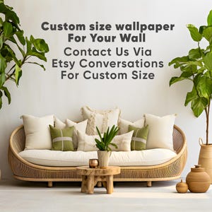 May include: A curved rattan sofa with cream cushions and green accent pillows, a small wooden coffee table, and two potted plants. The wall features the text: Custom size wallpaper For Your Wall Contact Us Via Etsy Conversations For Custom Size.