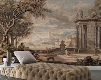 May include: A beige tufted velvet daybed with a rectangular white pillow, positioned in front of a large wall mural depicting a classical landscape with stone columns, trees, a harbor, and figures in a muted palette of brown, tan, and soft blue.