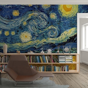 May include: A wall mural featuring a reproduction of The Starry Night with swirling blue and yellow brushstrokes. Below the mural is a long wooden bookshelf filled with various books, a white desk organiser, and small decorative objects.