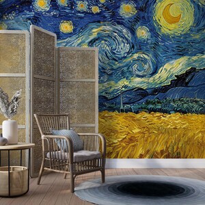 May include: A wall mural featuring a reproduction of Vincent van Gogh's Starry Night painting with a swirling blue sky, yellow crescent moon, and golden wheat field, positioned behind a light brown rattan chair and a three-panel woven room divider.