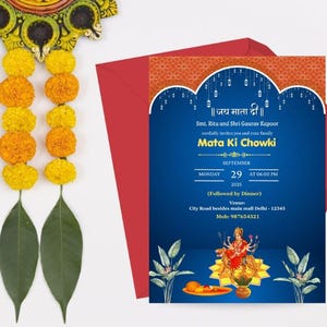 May include: An invitation card with a blue background and gold accents, featuring text in Hindi and English. The card is for a Mata Ki Chowki event, with details including the date, time, and venue. A red envelope is behind the card.