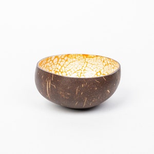 Coconut shell decorated with eggshells, orange