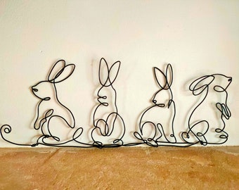 Famille lapins en fil de fer décoration murale nature minimaliste