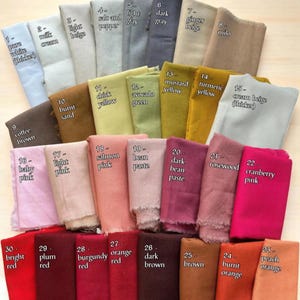 May include: A collection of fabric swatches arranged in a grid, each labelled with a number and colour name including pure white, milk cream, light beige, salt and pepper, light grey, dark grey, ginger beige, milo, coffee brown, burnt sand, chick yellow, avocado green, mustard yellow, turmeric yellow, cream beige, baby pink, light pink, salmon pink, bean paste, dark bean paste, rosewood, cranberry pink, bright red, plum red, burgundy red, orange red, dark brown, brown, burnt orange, and peach orange.