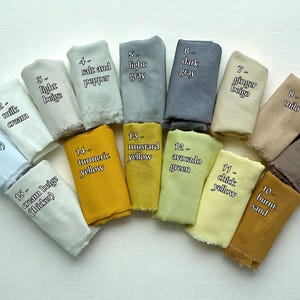 May include: A collection of fabric swatches in various colors, including pure white, cream beige, light beige, salt and pepper, light gray, dark gray, ginger beige, milo, coffee brown, and burnt sand. Each swatch is labeled with its color name.