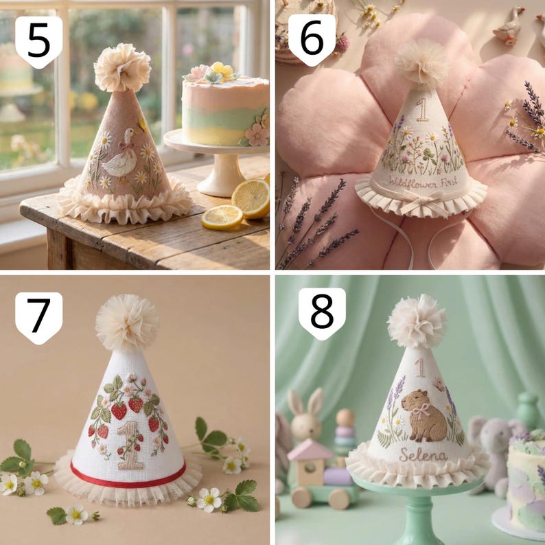 May include: A collection of four cone-shaped party hats featuring embroidered designs. One hat displays a goose, another features wildflowers with the text 'Wildflower First', one shows strawberries with the number '1', and the last depicts a capybara with the name 'Selena' and the number '1'. Each hat is topped with a tulle pom-pom and has a ruffled tulle trim at the base.
