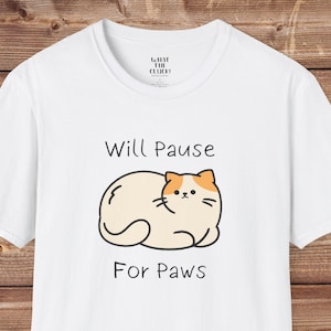 May include: White t-shirt with a cartoon cat and the text "Will Pause For Paws".