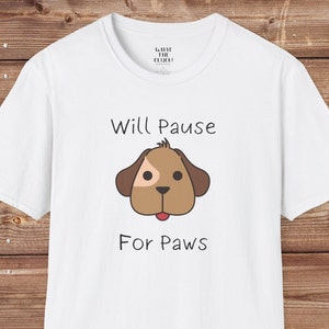 May include: White t-shirt with a brown cartoon dog and the text "Will Pause For Paws".