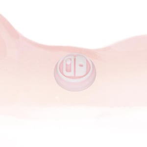 May include: A pale pink and white controller button, with the letters 'd' and 'b' in a rounded design. The button is set against a soft, watercolour-style background in shades of pink and white.