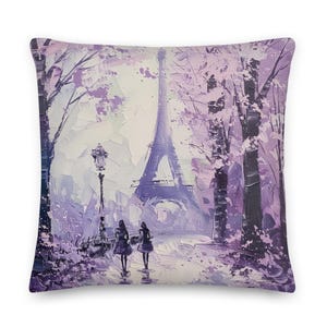 May include: Square throw pillow featuring an impressionistic painting of the Eiffel Tower in Paris. The artwork is rendered in shades of purple and white, depicting a street scene with two figures walking. The pillow has a soft, textured appearance.