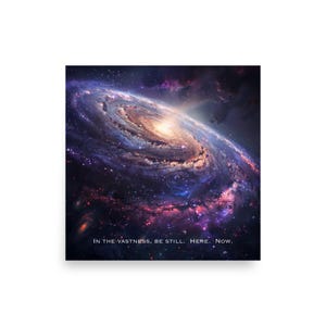 May include: A vibrant print featuring a spiral galaxy with shades of purple, blue, and gold. The image includes the text "IN THE VASTNESS, BE STILL. HERE. NOW."