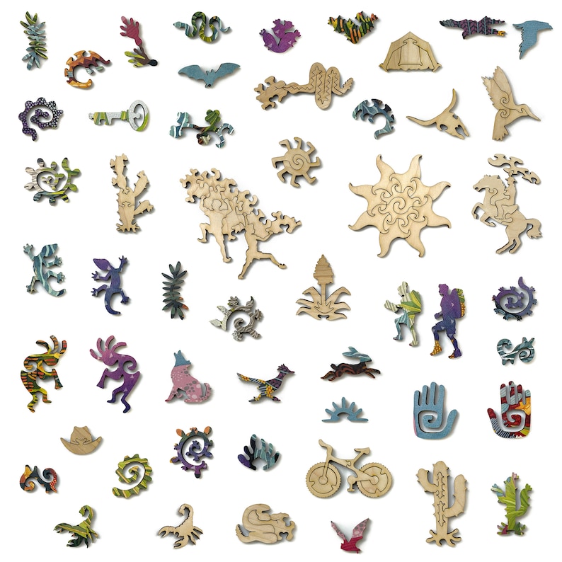 May include: A wooden jigsaw puzzle with a southwestern theme. The puzzle pieces are cut in the shapes of various desert animals, plants, and symbols. The pieces are painted in bright colors, including red, blue, green, and yellow.