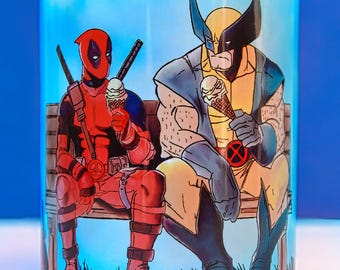 Deadpool and Wolverine Mug Sitting on Bench – Funny Marvel Superhero Cup – Gift for Comic Fans – 11 oz Ceramic Mug
