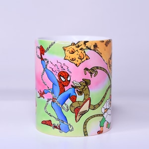 May include: A cylindrical mug featuring a colorful comic book illustration of Spider-Man in action. The design includes Spider-Man in a blue and red suit, battling villains with web-like lines and a vibrant background.