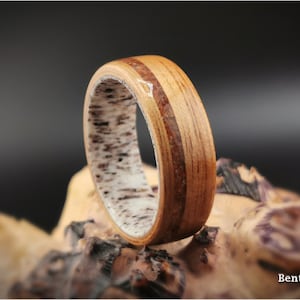 Bentwood Ring: Quartersawn Koa, offset inlaid Petrified Wood, Deer Antler core, wood ring