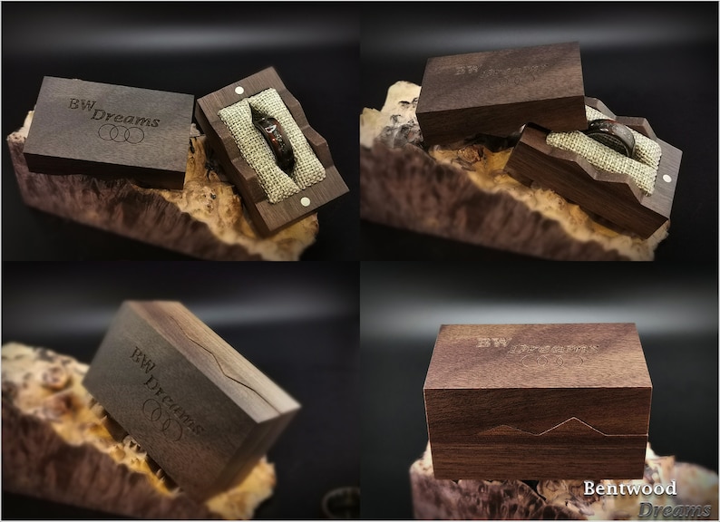 May include: A wooden ring box with a dark brown finish. The box is engraved with the text "BW Dreams" and has a small ring pillow inside. The box is open and the ring pillow is visible.