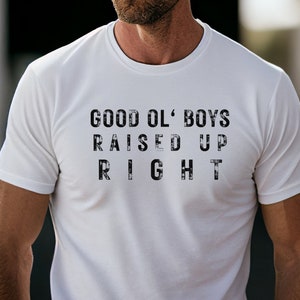 May include: White t-shirt with a black graphic print that reads "GOOD OL' BOYS RAISED UP RIGHT".