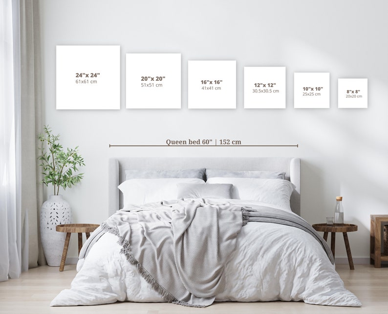 May include: A white queen-sized bed with a white headboard and a white blanket. The bed is in a room with white walls and a white floor. There are five white square frames on the wall above the bed. The frames are labeled with different sizes in inches and centimeters. The text "Queen bed 60" | 152 cm" is written below the frames.