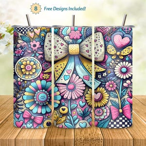 Puede incluir: Tres vasos de acero inoxidable con coloridos diseños florales y lazos. Los vasos presentan una variedad de flores, corazones y lazos en tonos rosa, azul, amarillo y blanco. El texto "8 Free Designs Included!" es visible en la parte superior izquierda.