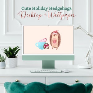 May include: A computer monitor displaying a digital desktop wallpaper featuring two cartoon hedgehogs wearing Santa hats. One hedgehog is holding a cup of hot chocolate with marshmallows and a candy cane. The other hedgehog is holding a gift. The text "Cute Holiday Hedgehogs Desktop Wallpaper" is displayed above the image.
