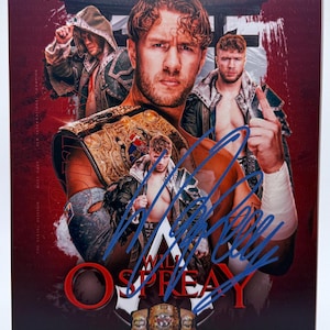 May include: A promotional image featuring a professional wrestler with a championship belt. The image has a red background with the wrestler's image and signature in blue. The wrestler is wearing a championship belt and has a serious expression.