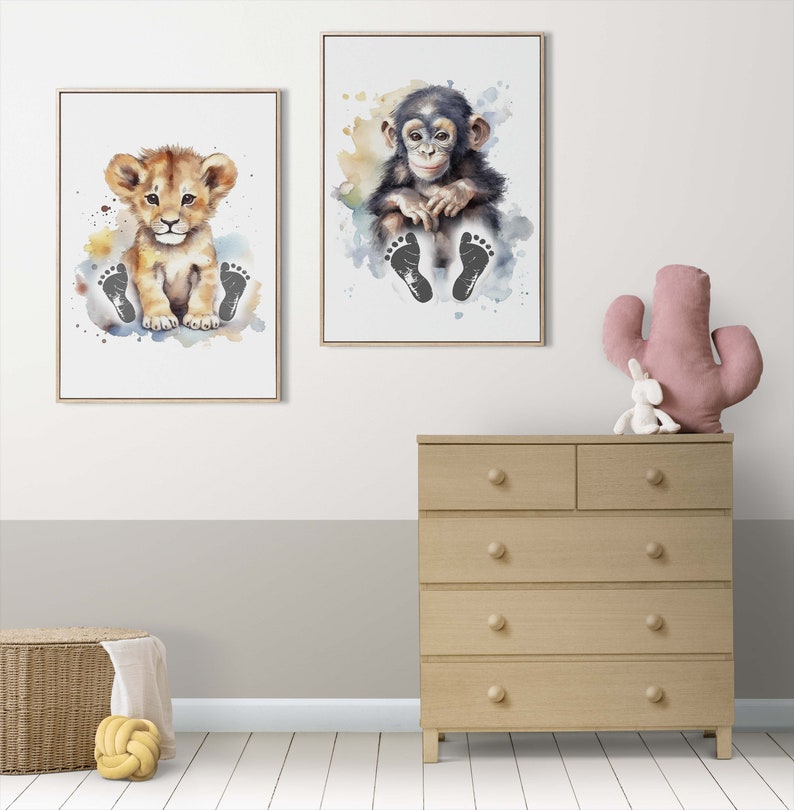 May include: Two watercolor prints featuring animal footprints. The first print shows a lion cub with brown fur and a light brown mane sitting on a light blue background with black footprints. The second print shows a chimpanzee cub with black fur sitting on a light blue background with black footprints.