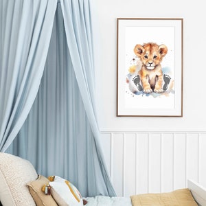 May include: A watercolor painting of a cute lion cub sitting on a cloud with paw prints. The painting is framed in a light brown frame and is hanging on a white wall.