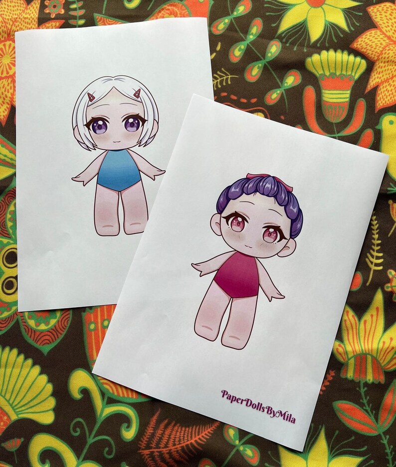 May include: Two paper dolls are depicted, each with a unique hairstyle and swimsuit. One doll has white hair and a blue swimsuit, while the other has purple hair and a pink swimsuit. The text "Paper Dolls By Mila" is visible on the bottom right.