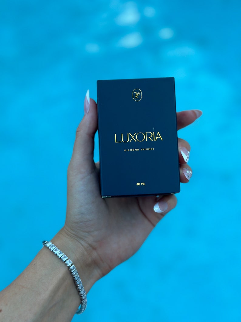 May include: A black box with gold lettering that reads "LUXORIA DIAMOND SHIMMER" and "40 ML".