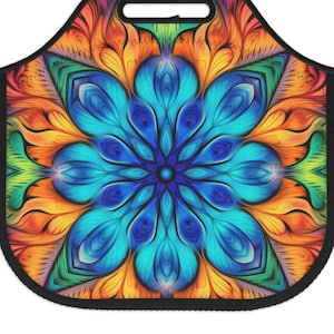May include: A colorful reusable lunch bag with a mandala design featuring blue, orange, yellow, and green hues. The bag has a black handle and a zipper closure.
