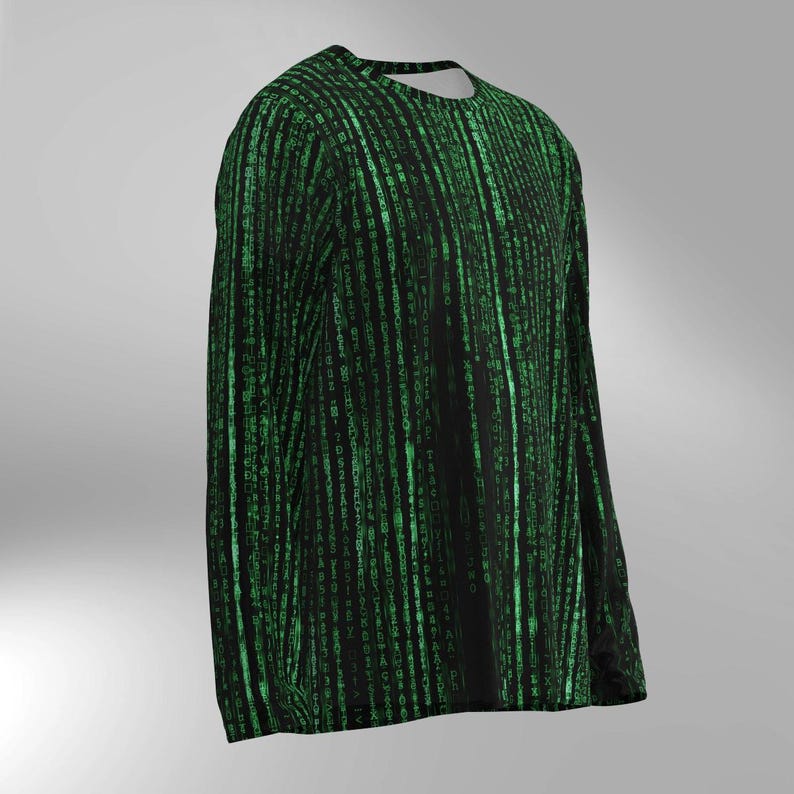 May include: Black long-sleeved shirt with a green binary code pattern. The design features vertical lines of green characters, creating a digital rain effect. The shirt has a crew neck and a relaxed fit.
