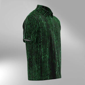 May include: A black polo shirt with a green digital rain pattern. The short-sleeved shirt has a collared neckline and a buttoned placket. The design features vertical lines of green characters against a black background, creating a tech-inspired aesthetic.