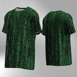 May include: A black t-shirt with a green digital rain pattern, shown from the front and back. The design features vertical lines of green characters resembling code. The shirt has short sleeves and a crew neck.